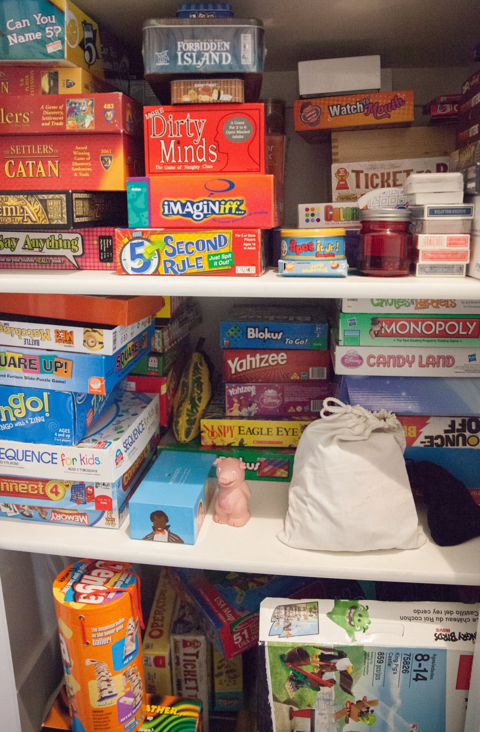 Stacked family games in hallway closet